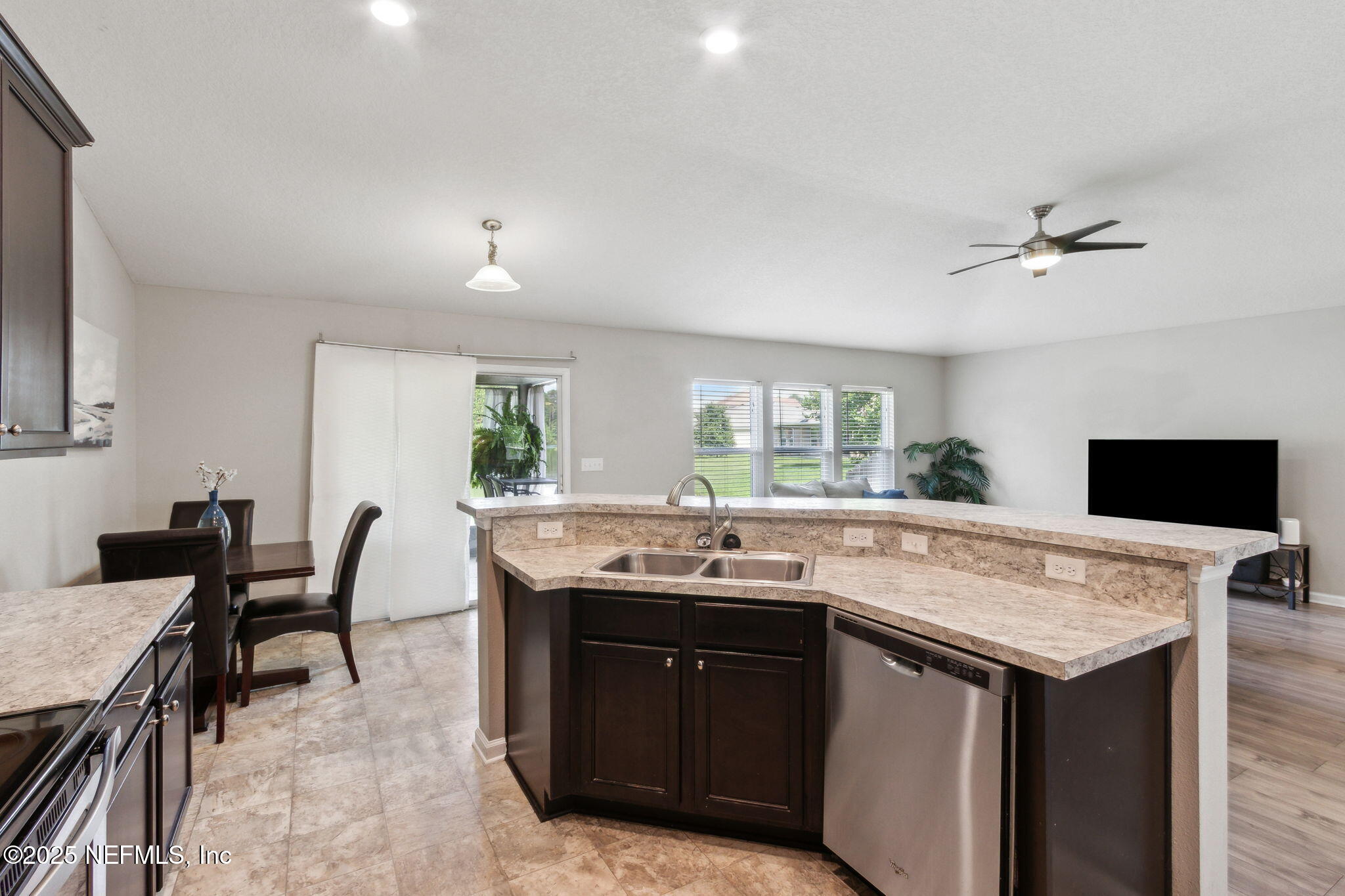 7197 Steventon Way Jacksonville, FL 32244 - Photo 20 of 58 a kitchen with a sink and a stove with wooden floor