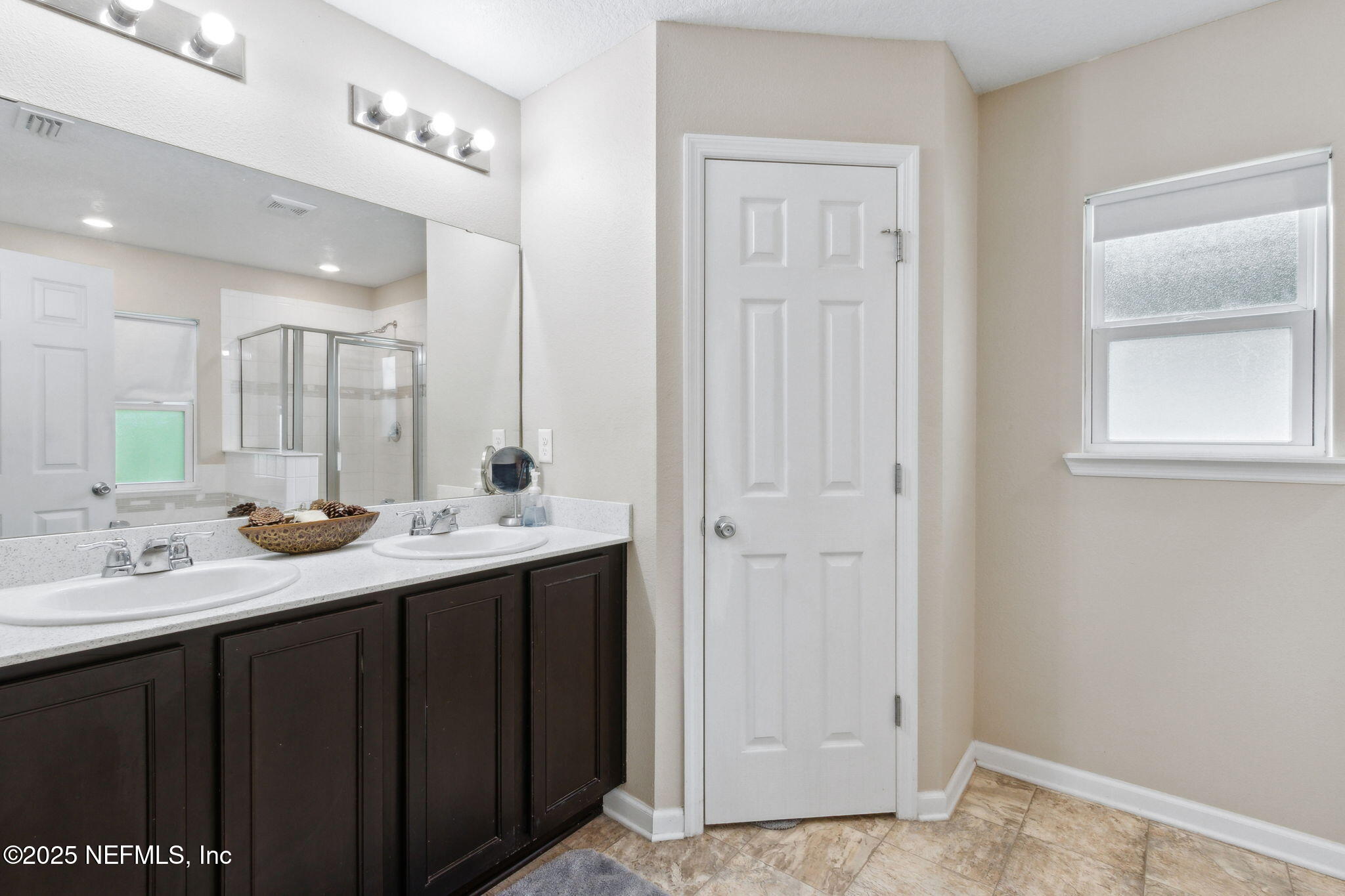 7197 Steventon Way Jacksonville, FL 32244 - Photo 25 of 58 a bathroom with a double vanity sink and a mirror