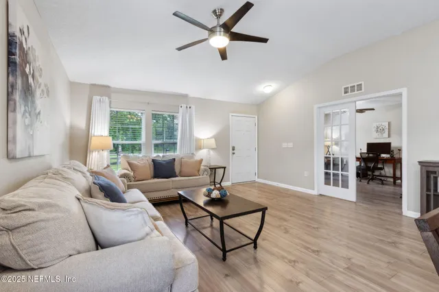 a living room with furniture and a flat screen tv