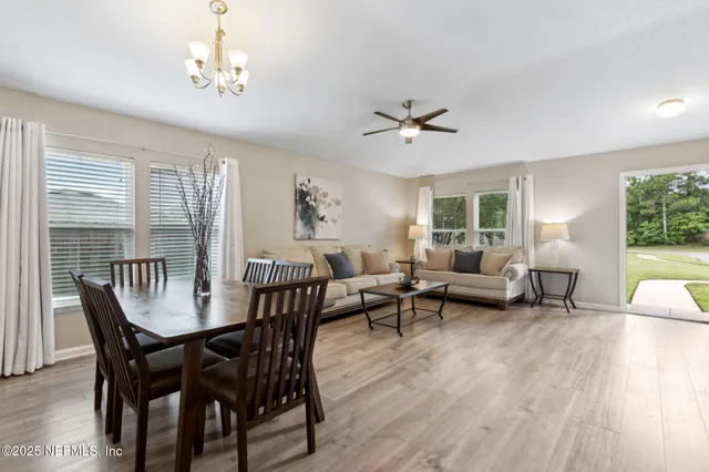 a living room with furniture or kitchen and a wooden floor