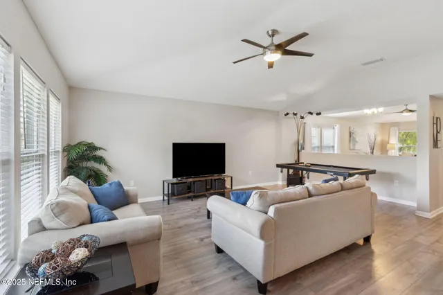 a living room with furniture and a flat screen tv