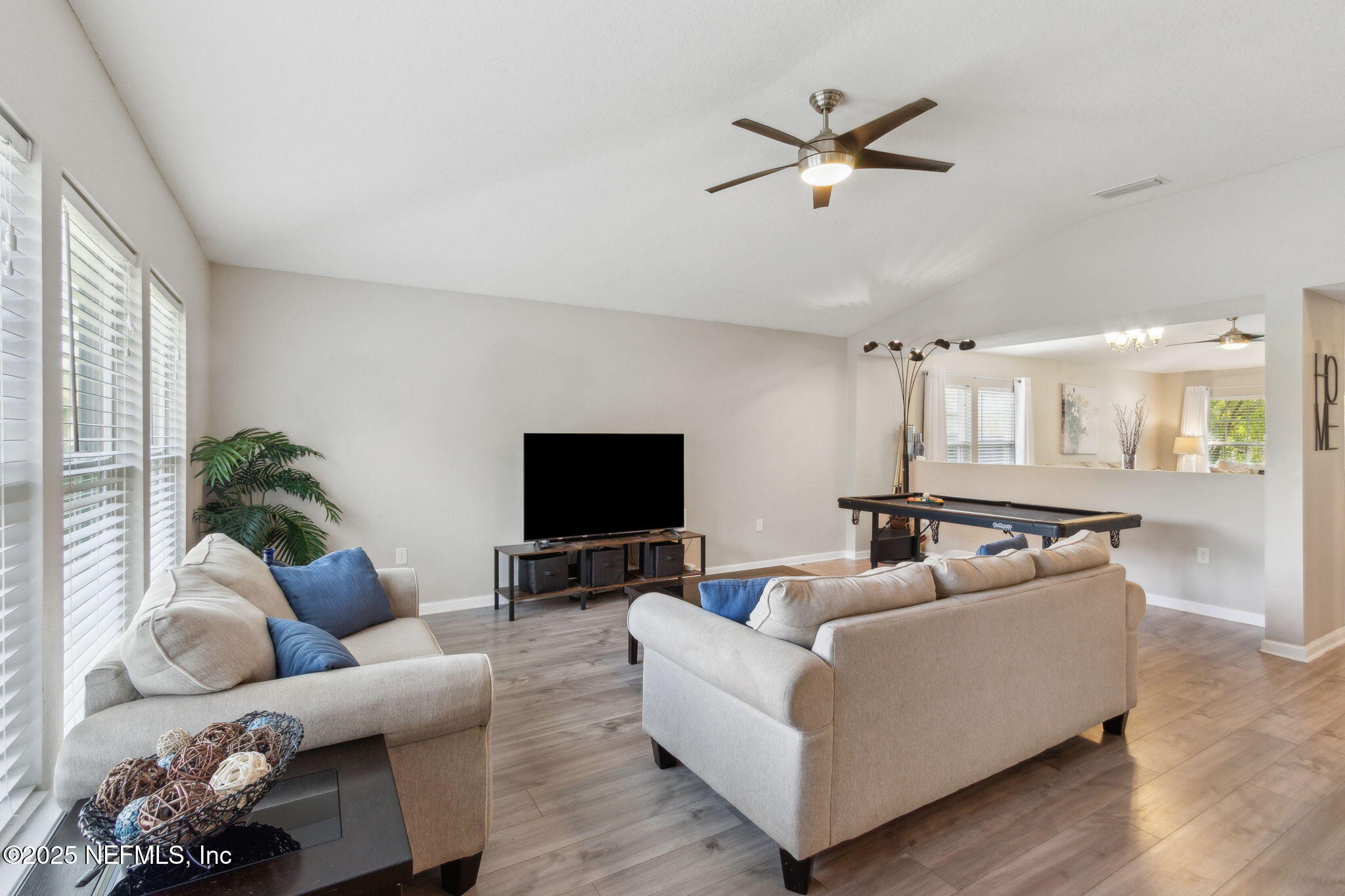 7197 Steventon Way Jacksonville, FL 32244 - Photo 7 of 58 a living room with furniture and a flat screen tv with wooden floor