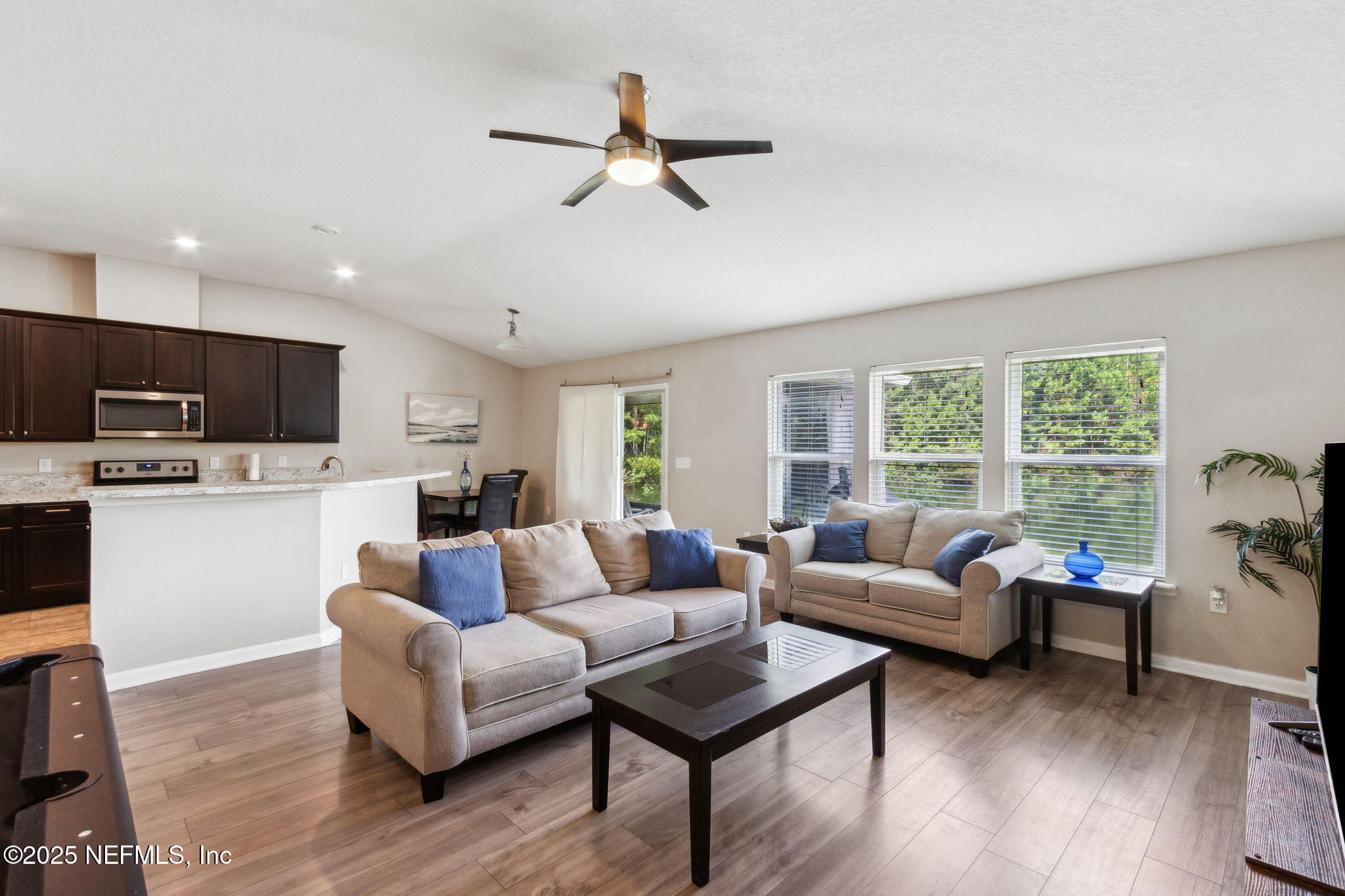 7197 Steventon Way Jacksonville, FL 32244 - Photo 9 of 58 a living room with furniture or kitchen and a wooden floor
