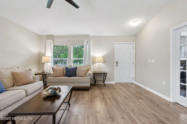 a kitchen with stainless steel appliances kitchen island granite countertop a refrigerator a stove a sink a dining table and chairs