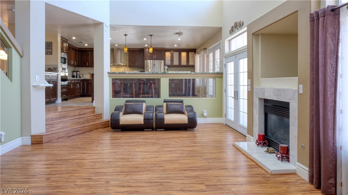 3704 North Campbell Road Las Vegas, NV 89129 - Photo 20 of 38 A grand living space with rich wood flooring and a classic fireplace offers comfortable gatherings.