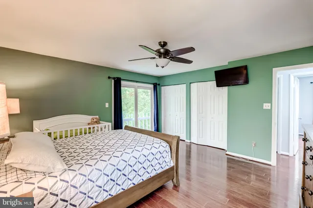 a bedroom with a large bed and a window