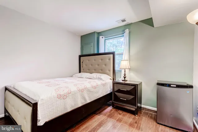 a bed sitting in a bedroom next to a window