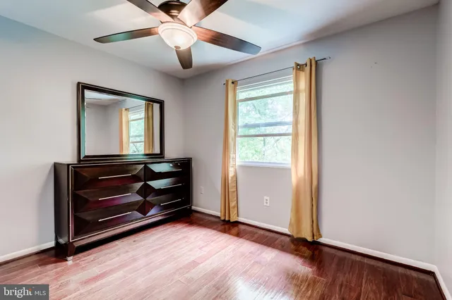 a view of room with window and wooden floor