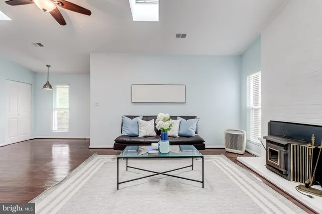 a living room with furniture a fireplace and a window