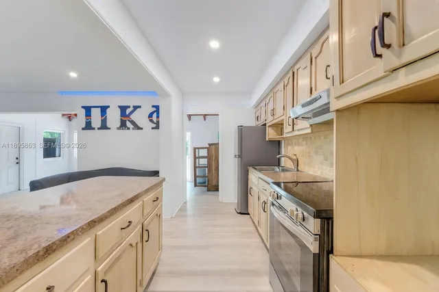 a kitchen with stainless steel appliances granite countertop a sink and cabinets