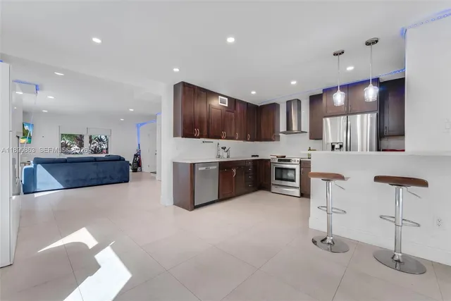 a large kitchen with a table and chairs in it
