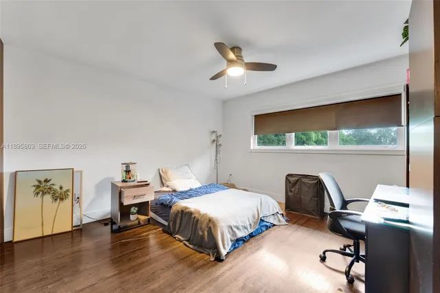 a spacious bedroom with a bed and window