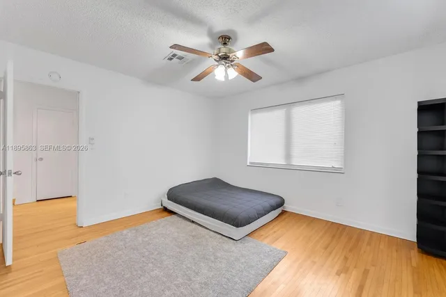 a living room with a bed furniture and a window