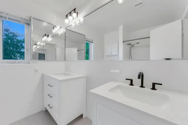 a bathroom with a sink a mirror and vanity