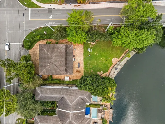 an aerial view of a house with a yard