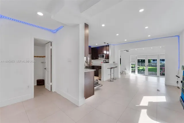 a view of a kitchen with kitchen island wooden floor center island and stainless steel appliances