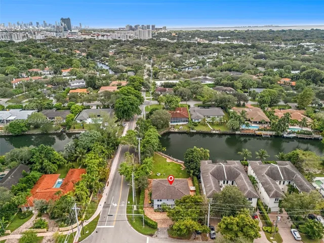 an aerial view of lake and residential houses with outdoor space