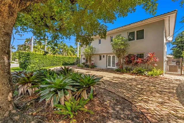 a view of a house with a yard and garden