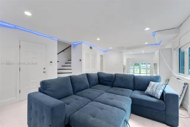 a living room with furniture white walls and white walls