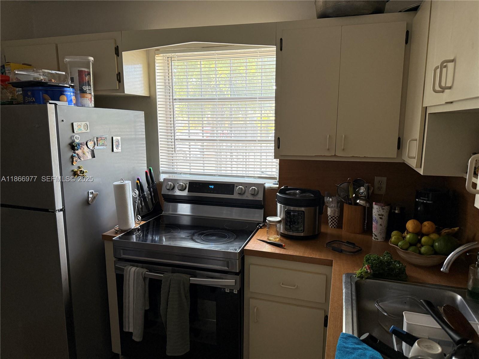 502 Southwest 13th Avenue Miami, FL 33135 - Photo 20 of 48 a kitchen with a refrigerator and a stove top oven