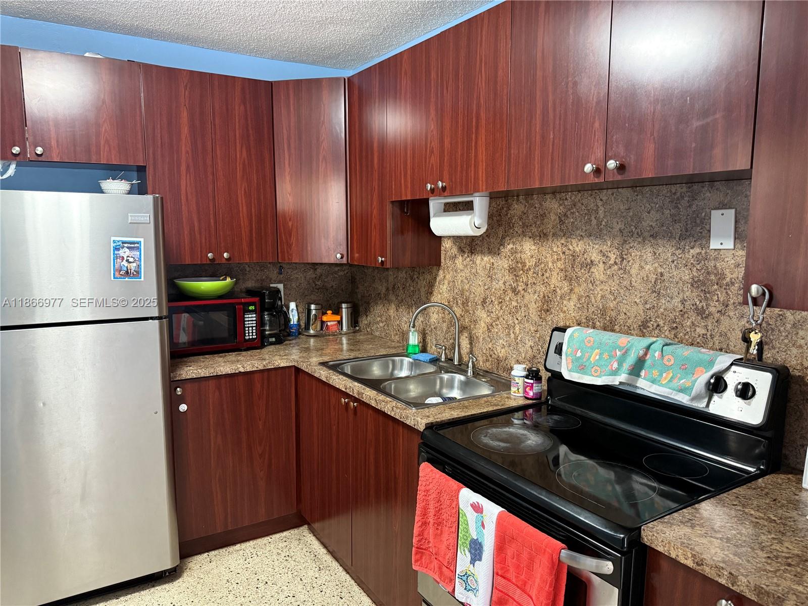 502 Southwest 13th Avenue Miami, FL 33135 - Photo 24 of 48 a kitchen with a stove and a refrigerator