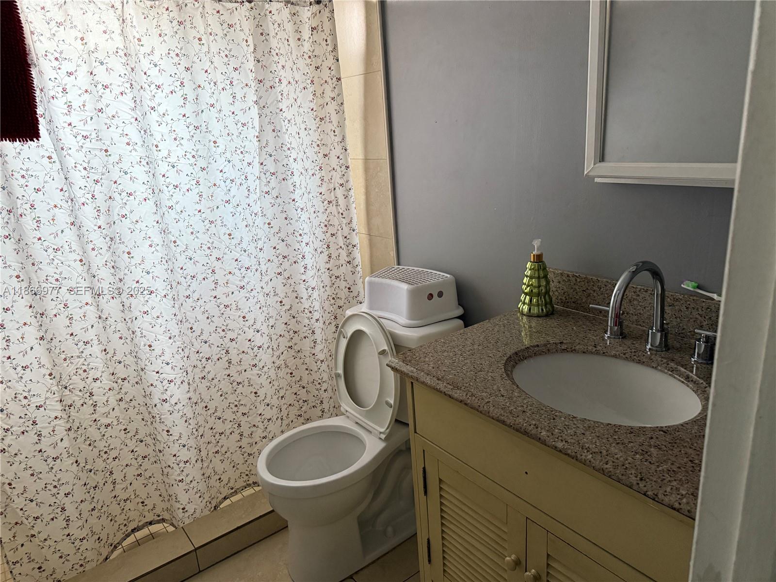 502 Southwest 13th Avenue Miami, FL 33135 - Photo 25 of 48 a bathroom with a granite countertop sink and a mirror