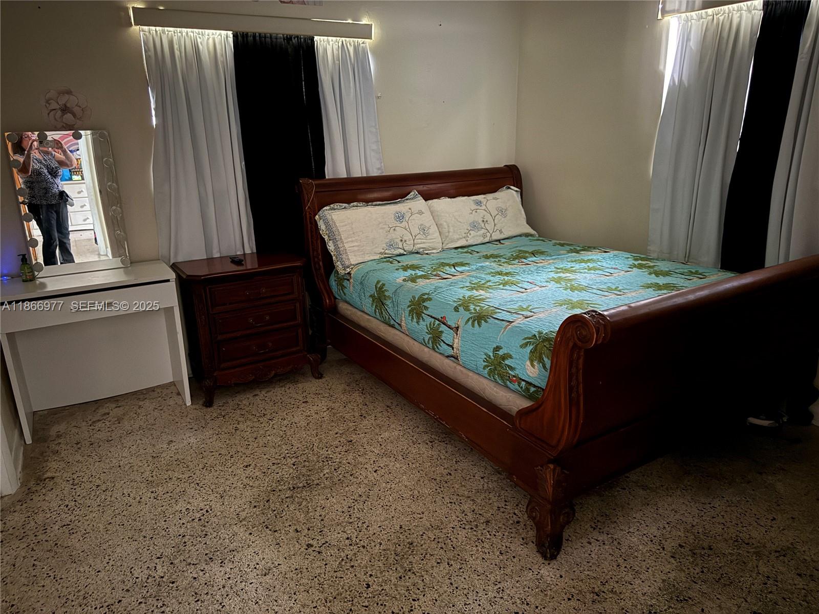 502 Southwest 13th Avenue Miami, FL 33135 - Photo 28 of 48 a bed sitting in a bedroom next to a window