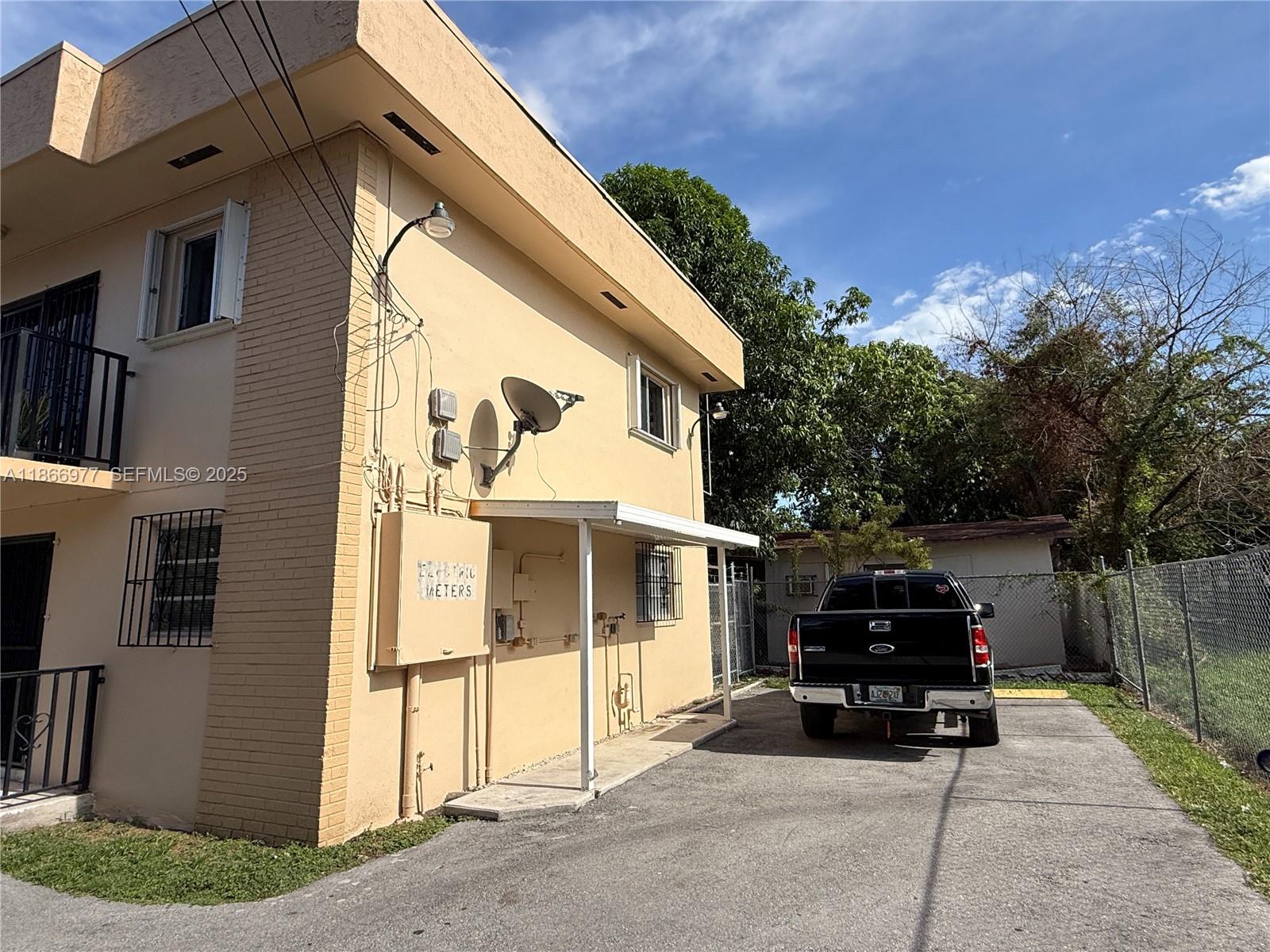 502 Southwest 13th Avenue Miami, FL 33135 - Photo 34 of 48 a view of a house with a barbeque and wooden stairs