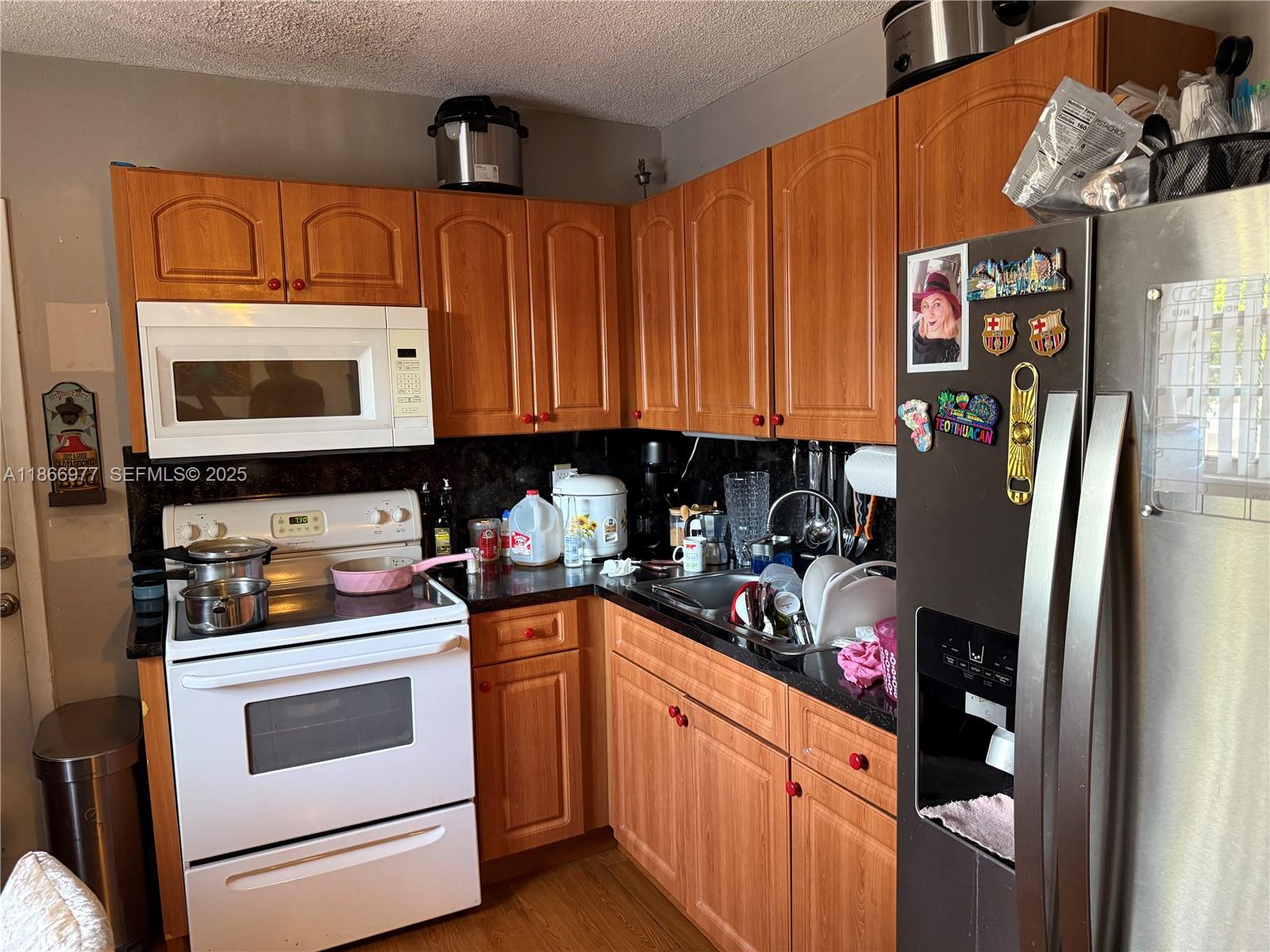 502 Southwest 13th Avenue Miami, FL 33135 - Photo 39 of 48 a kitchen with stainless steel appliances granite countertop a refrigerator stove and sink