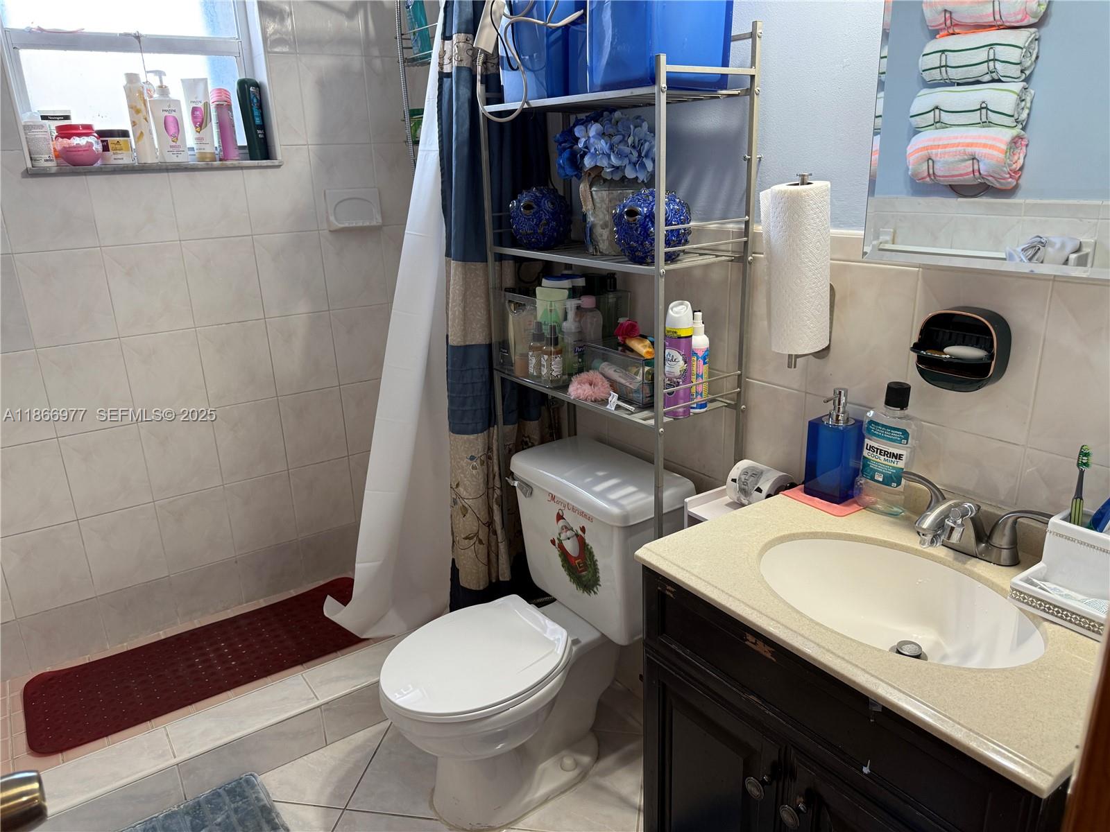 502 Southwest 13th Avenue Miami, FL 33135 - Photo 40 of 48 a bathroom with a sink a toilet and a shower curtain