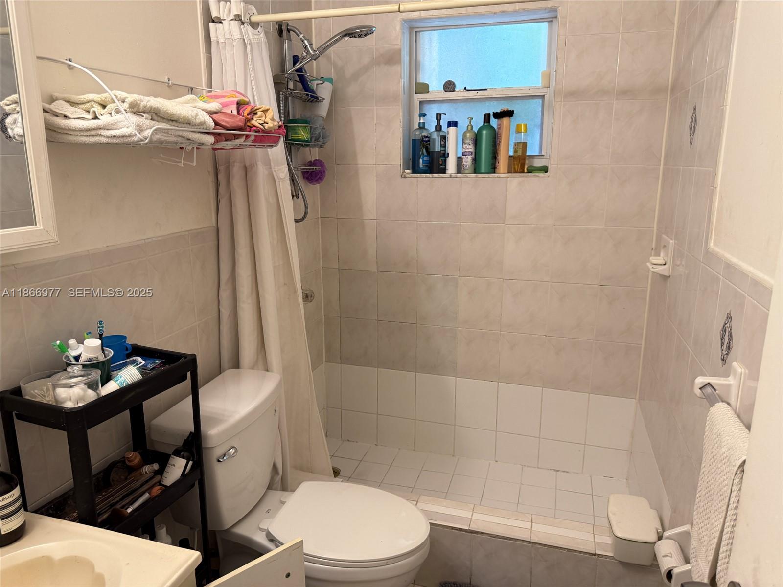 502 Southwest 13th Avenue Miami, FL 33135 - Photo 46 of 48 a bathroom with a toilet a sink and shower