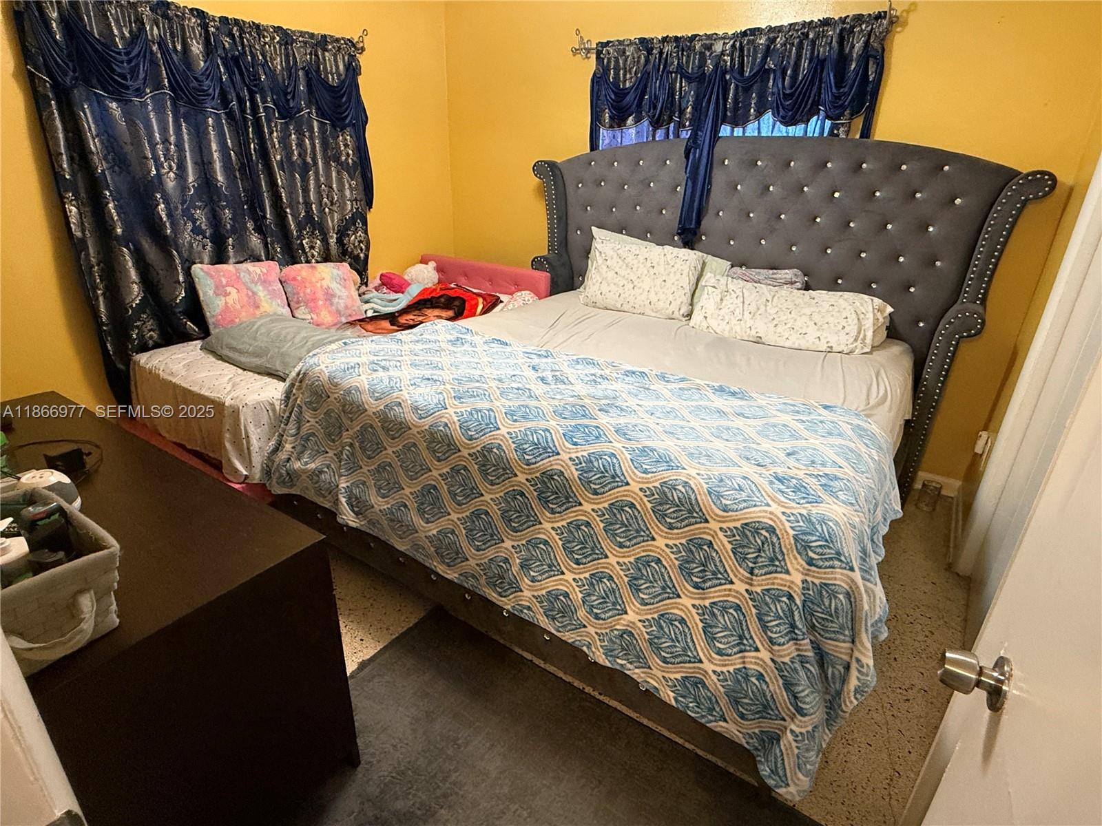 502 Southwest 13th Avenue Miami, FL 33135 - Photo 48 of 48 a bed sitting in a bedroom next to a window
