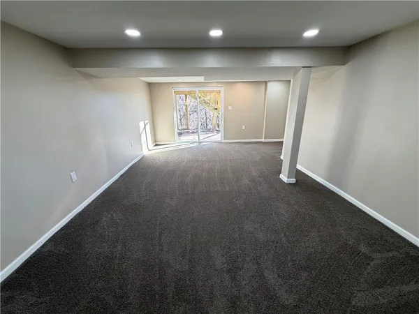 an empty room with a space and windows