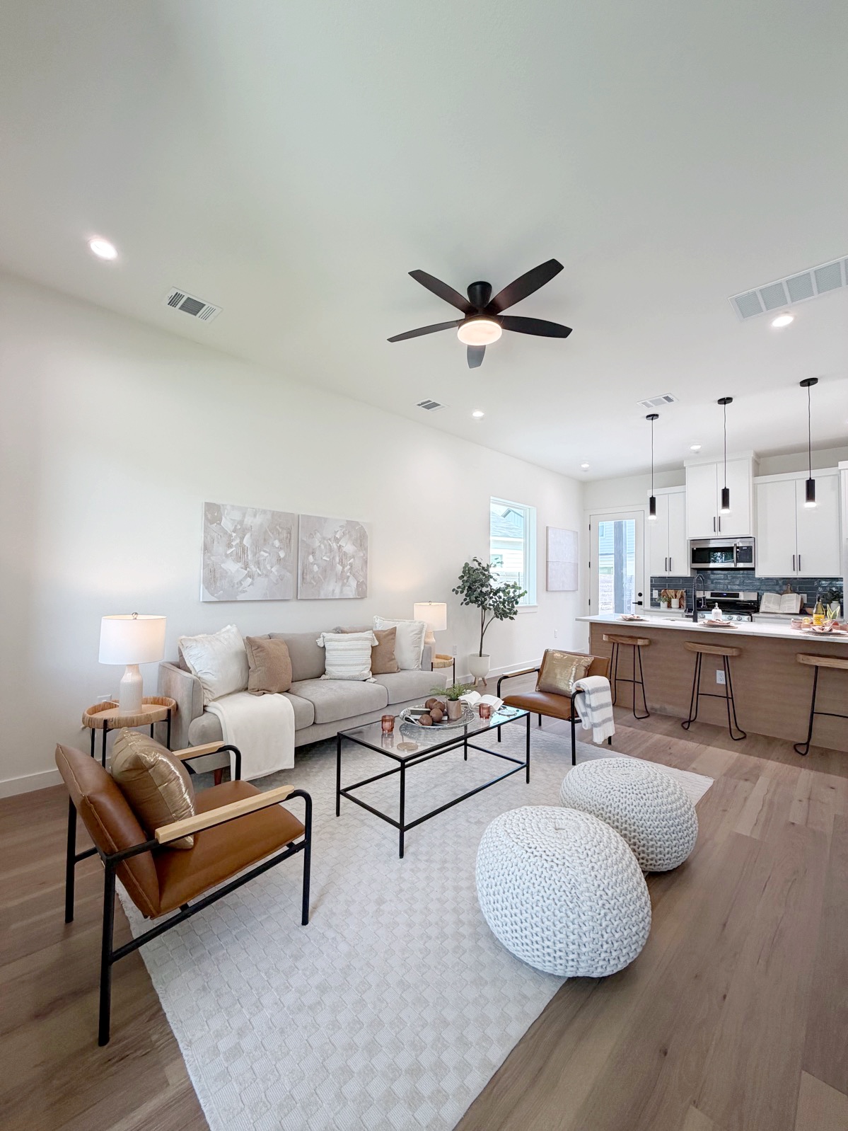 6809 Porter Street, Unit 1 Austin, TX 78741 - Photo 2 of 10 An inviting open-concept living space features a cozy seating arrangement and a modern kitchen island.