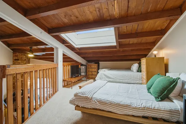 a bedroom with double bed and a large window