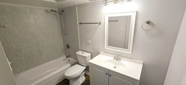 a bathroom with a sink toilet and shower
