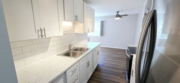 a kitchen with a sink and a refrigerator