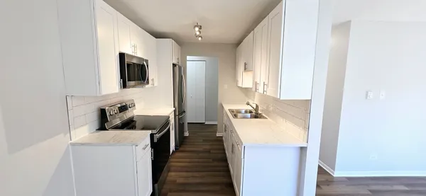 a hallway with furniture a flat screen tv and a fireplace