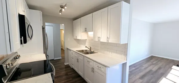 a kitchen with a sink stove and refrigerator