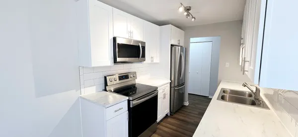 a kitchen with a refrigerator stove and microwave