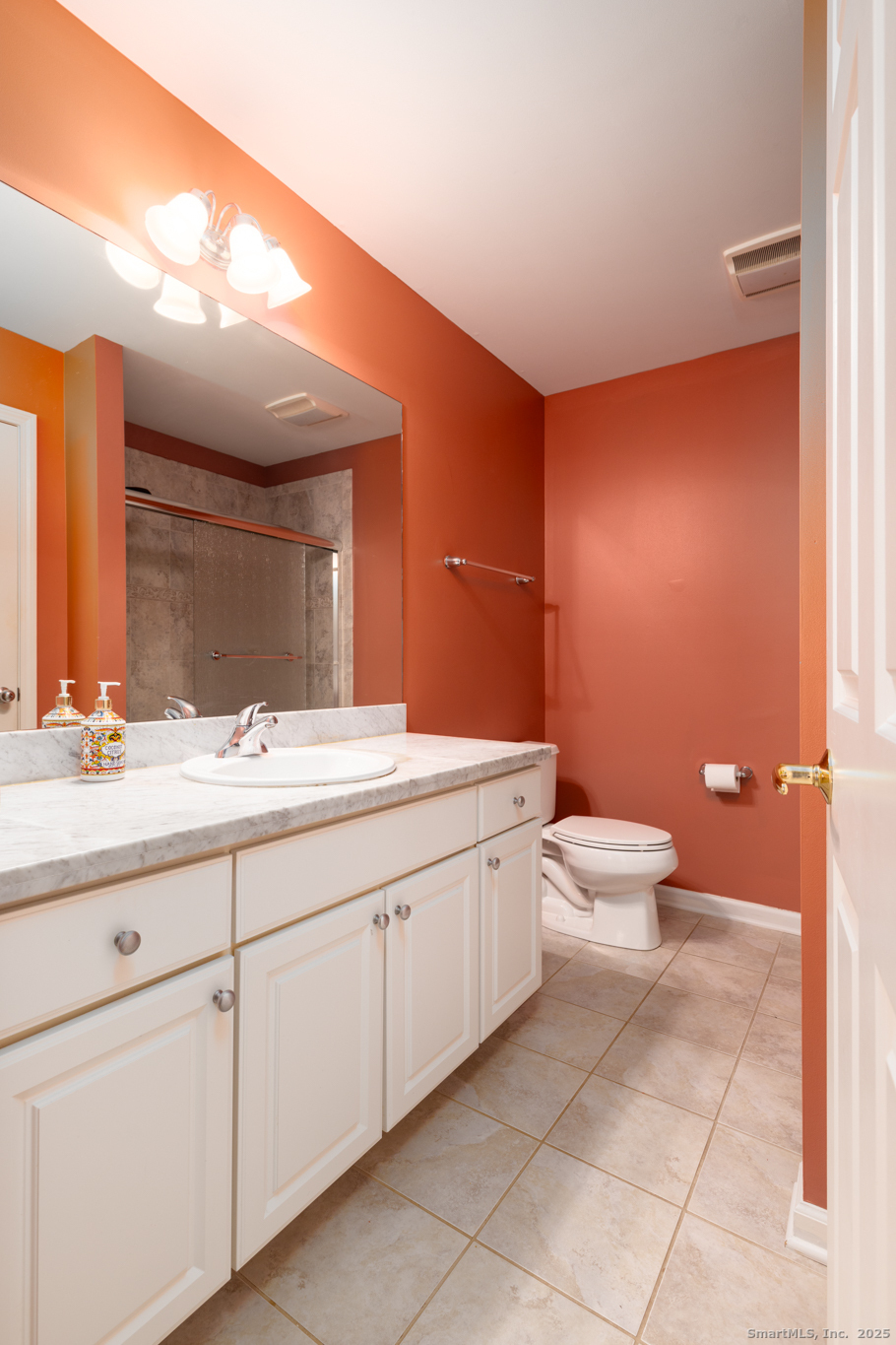 49 Park Pl Circle, Unit 49 West Hartford, CT 06110 - Photo 12 of 33 a bathroom with a toilet a sink and mirror