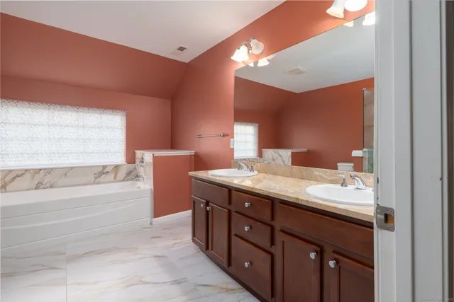 a bathroom with a bathtub and sink