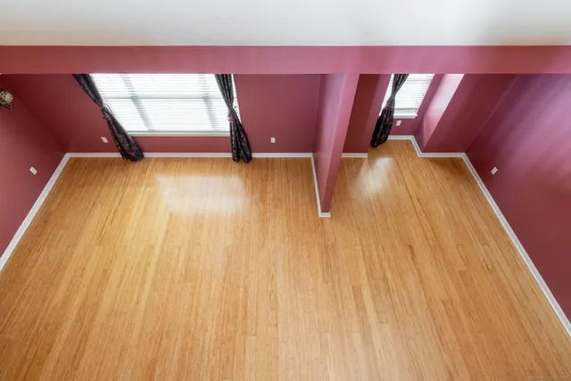 a spacious bathroom with a toilet a sink and mirror