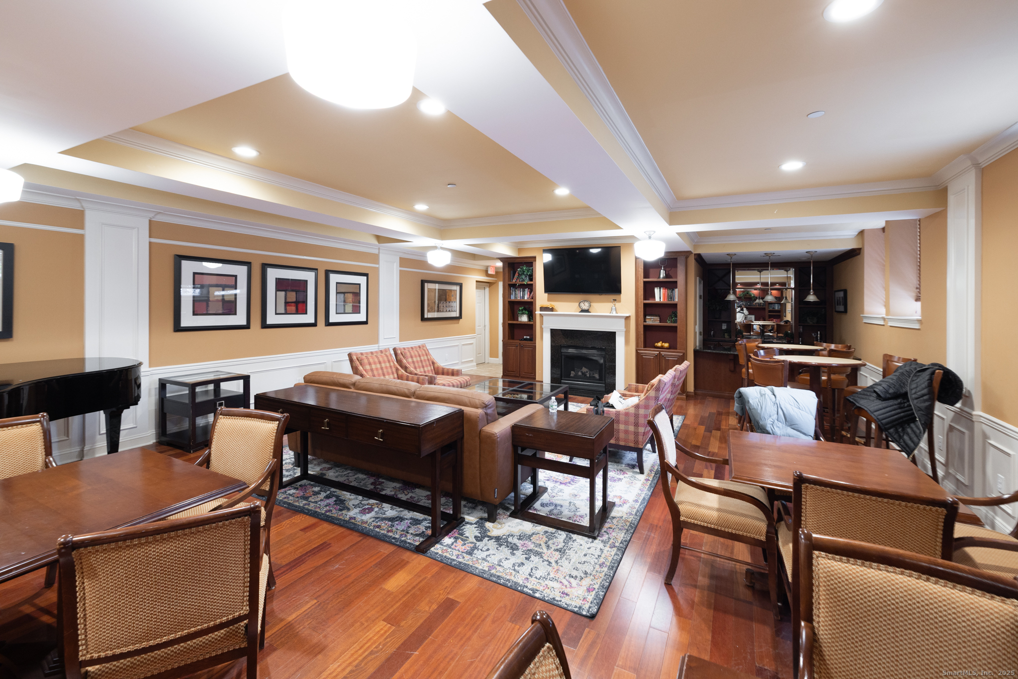 49 Park Pl Circle, Unit 49 West Hartford, CT 06110 - Photo 31 of 33 a living room with furniture a fireplace and a table