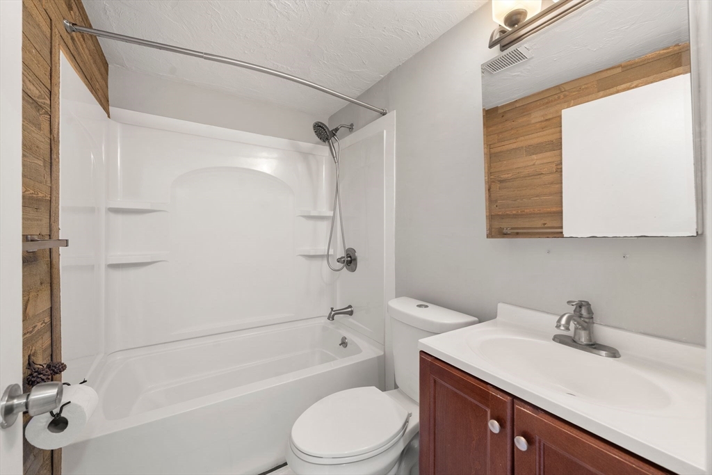 9 Tideview Path, Unit 10 Plymouth, MA 02360 - Photo 8 of 9 a bathroom with a sink toilet vanity and shower