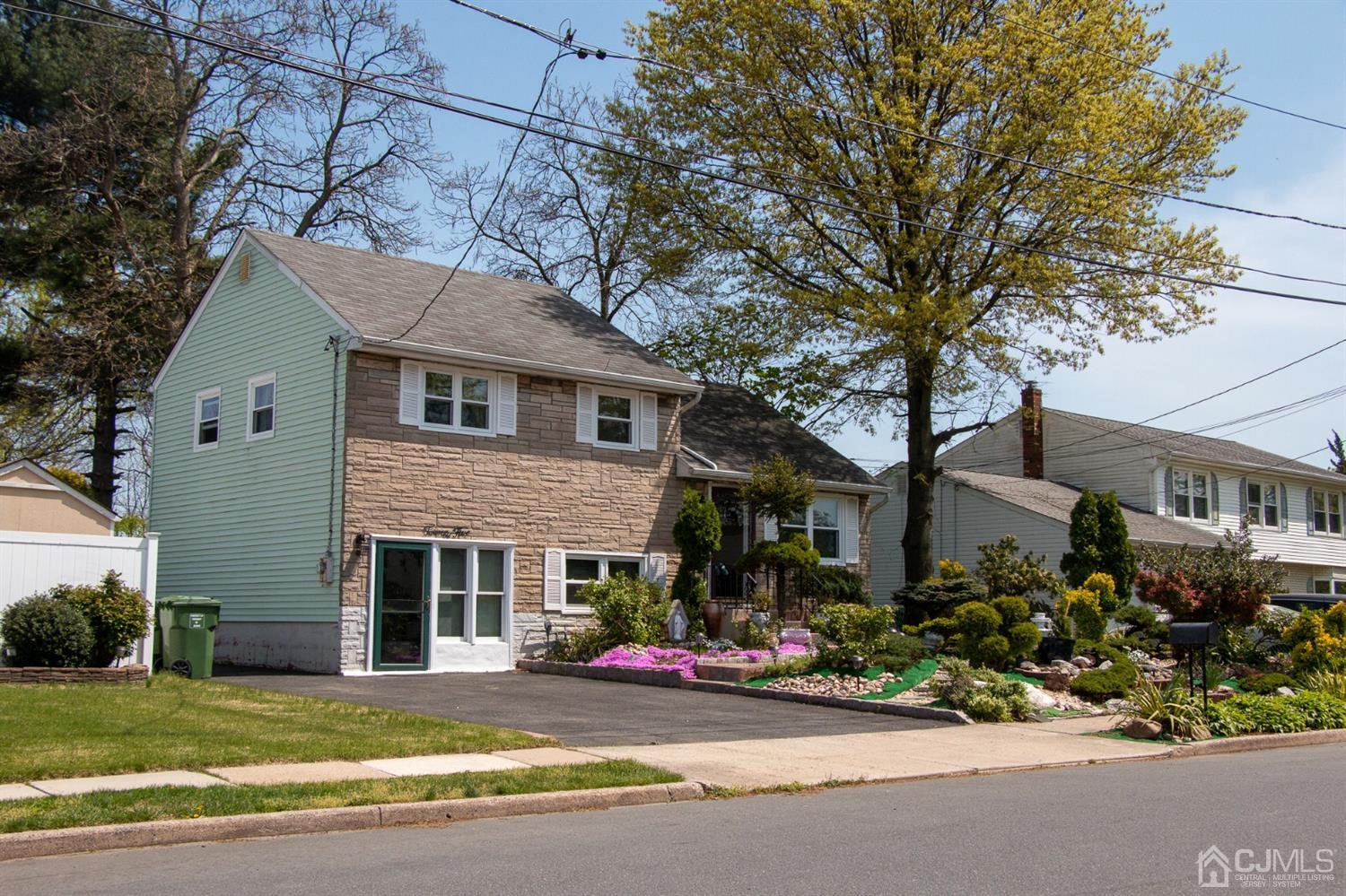 25 Wilshire Road Edison, NJ 08817 - Photo 16 of 18 a front view of a house with garage and outdoor seating