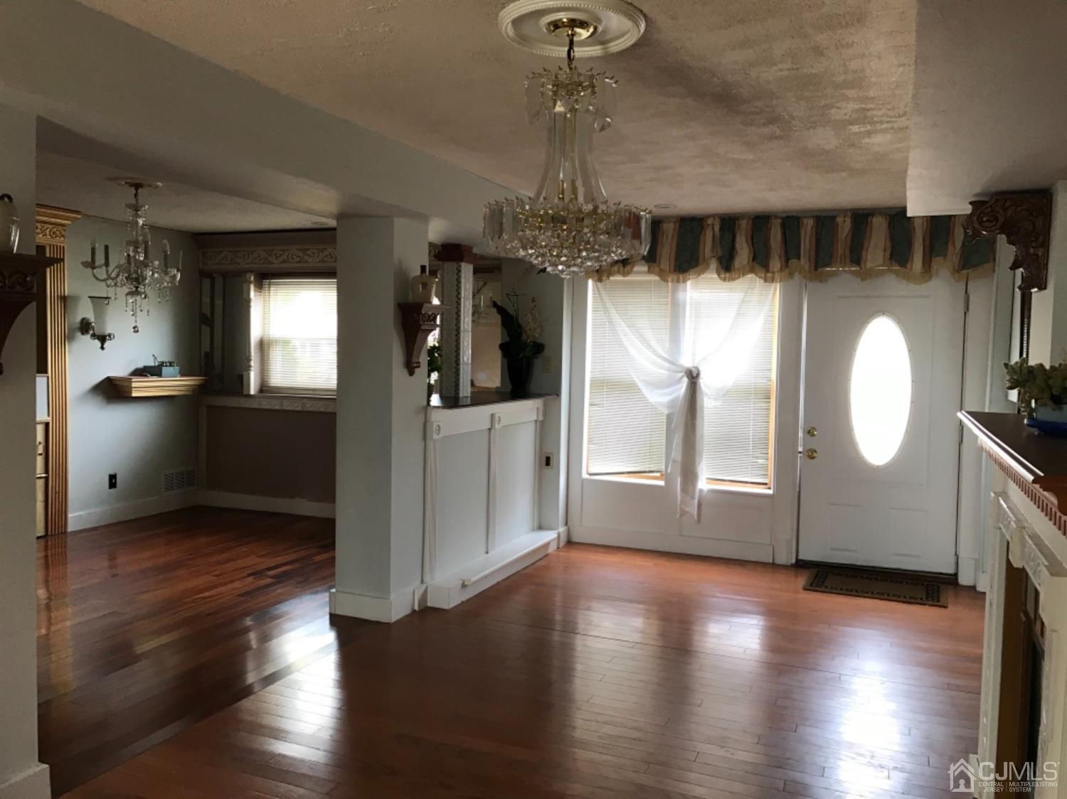 25 Wilshire Road Edison, NJ 08817 - Photo 3 of 18 a view of a kitchen with a sink dishwasher a kitchen island a stove and a wooden floors