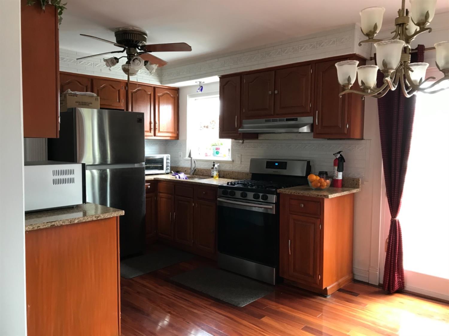 25 Wilshire Road Edison, NJ 08817 - Photo 9 of 18 a kitchen with stainless steel appliances granite countertop a refrigerator a sink a stove a microwave and cabinets