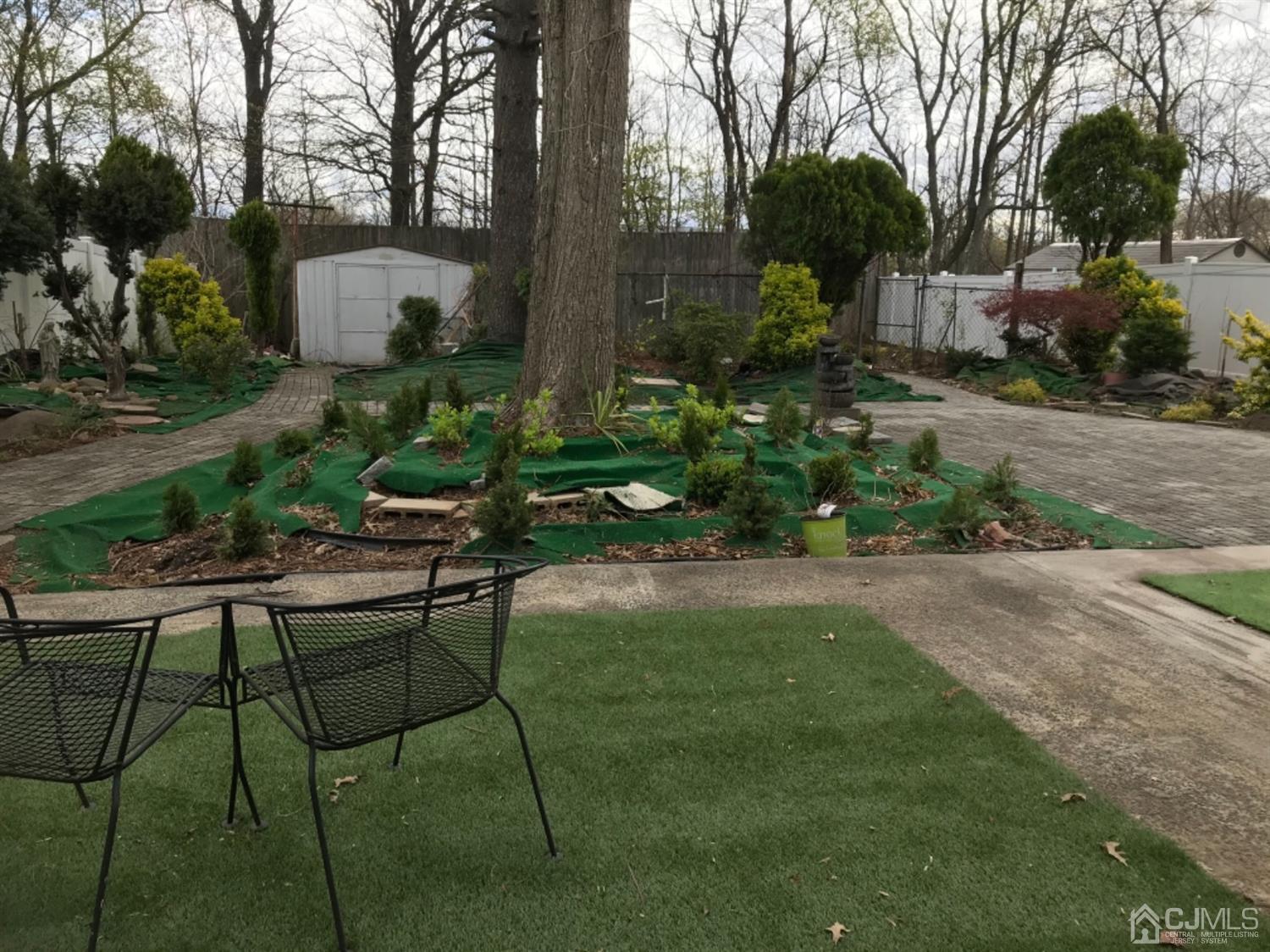25 Wilshire Road Edison, NJ 08817 - Photo 10 of 18 a view of backyard with table and chairs and potted plants