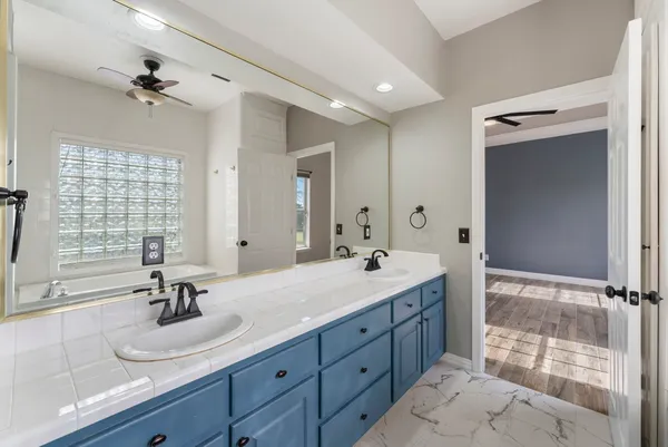 a bathroom with a double vanity sink large mirror and